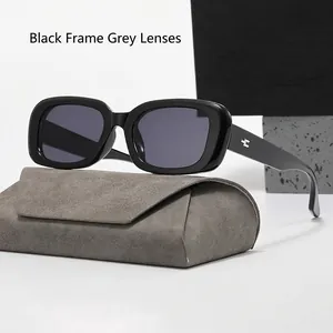 Close-up of black rectangular sunglasses with gray lenses and a suede folding case