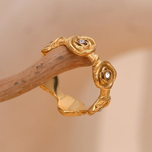Macro detail of 18K gold plated stainless steel ring with rose flower relief and crystals