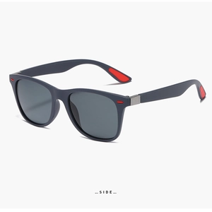 Detail of polarized sports sunglasses with matte black frame and red rubber padding