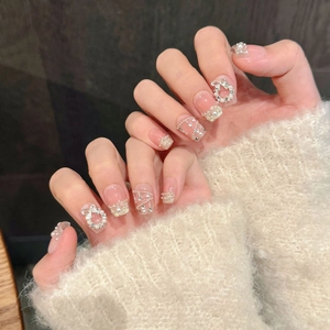 Short square nude press-on nails with pearls, rhinestones and silver festive wreaths