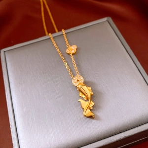 Close-up of golden koi fish and butterfly pendants with zircon inlay on a luxury necklace