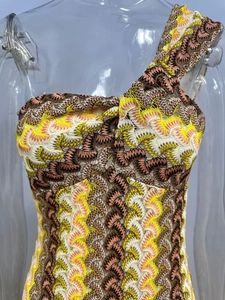 Detail of multi-color zigzag crochet knit dress with elegant one-shoulder neckline
