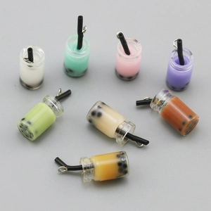 Flat lay macro of colorful resin bubble tea charms with metallic hanging rings