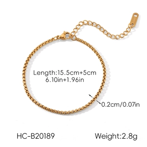 Detail view of golden stainless steel box chain bracelet with lobster clasp and extension