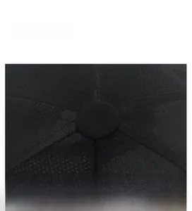 Close-up of the black baseball cap top button and detailed reinforced stitching texture