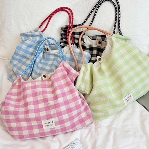 Detailed set of four plaid tote bags in pink, blue, green and black with woven handles