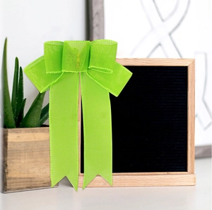 Detailed lime green mesh ribbon bow with v-cut tails for festive party decoration