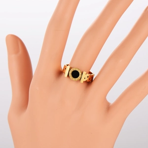 Gold stainless steel ring featuring black round center and Roman numeral engravings