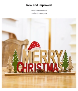Close-up of wooden Merry Christmas desktop ornament in festive red and green colors