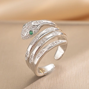 Silver snake-shaped open ring featuring green stone eyes and clear zircon body accents