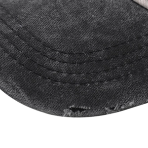 Macro detail shot showing the distressed edge and stitching on a black denim hat brim