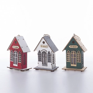 Three festive wooden Christmas house ornaments in red, white and green with X-mas engravings