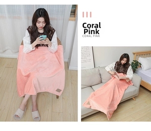 Detail of soft coral pink flannel fleece blanket used as a cozy leg cover at home