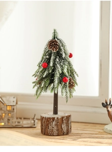 Detail of 24cm mini snowy Christmas tree with red berries on a rustic wooden base