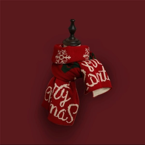Detail of red Christmas scarf featuring white Merry Christmas lettering and snowflake patterns