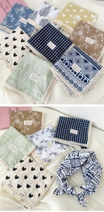 Close-up of cotton linen square scarf with delicate lace edge and floral patterns