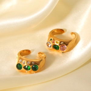 Golden irregular hammered stainless steel rings with colorful zircon on gold silk fabric