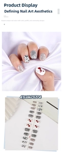 Close-up of heart pattern press-on nail stickers with grey, black and red heart motifs
