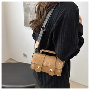 Brown Boston bag featuring a vintage printed wide strap and gold knob lock detail