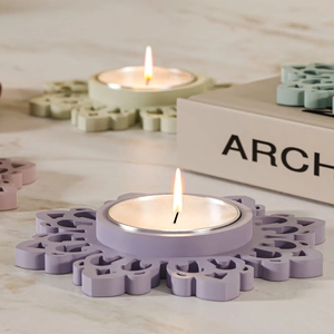 Lavender flower-shaped tea light candle holder with intricate hollow patterns and matte finish