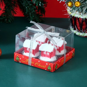 Close-up of 4 red house Christmas candles in a clear gift box with silver ribbon bow
