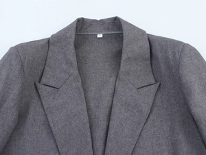 Close-up of the grey blazer collar showing the fabric texture and the size S label