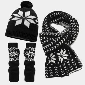 Detail of black and white snowflake knitted set including scarf, hat, and fingerless gloves
