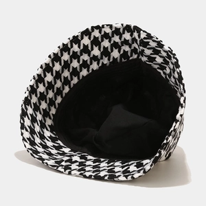 Black and white houndstooth fisherman hat with thick warm knit texture for winter