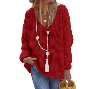 Detailed close-up showing the knit texture and V-neck of this loose red sweater