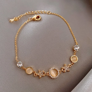 Elegant gold star bracelet with opal effect stones and sparkling cubic zirconia in macro view