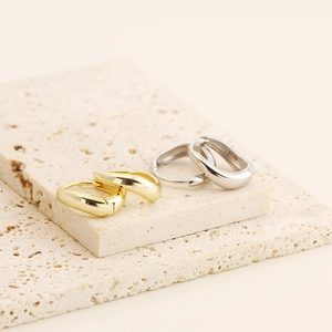 Detail of gold and silver S925 sterling silver irregular geometric hoop earrings
