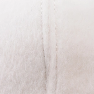 Macro view of soft white faux rabbit fur texture and neat stitching on baseball cap