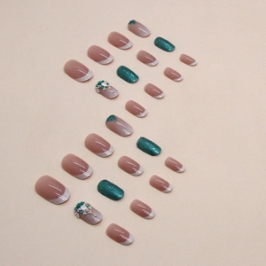 French oval fake nails in emerald green with glitter and luxury rhinestone embellishments