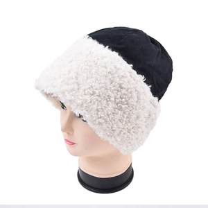 Winter women's bucket hat with black knit top and white faux lamb wool brim for warmth