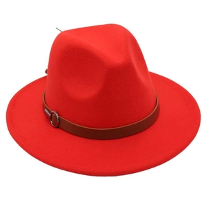 Close-up of red wool felt fedora featuring a brown leather band and silver metal buckle