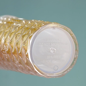 Detailed macro view of the BPA-free plastic tumbler base with gold glitter texture