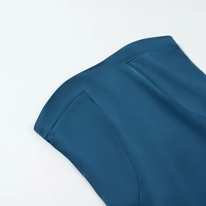 Detail shot of the stitching and satin texture of this peacock blue tube dress