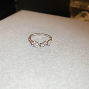 Close-up of butterfly zircon ring featuring a pink enamel flower and adjustable silver band