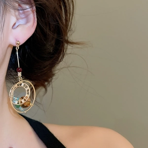 Close-up of vintage multi-loop gold earrings with colorful crystal beads on model
