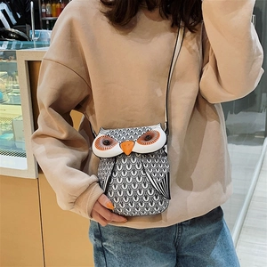 Detailed view of owl-shaped crossbody bag on a model to show actual size and fit