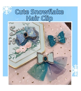 Detail of glitter bow hair clips with blue gems and snowflake charms for girls