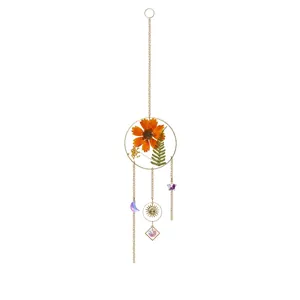 Bohemian sun catcher with orange dried flowers and crystal pendants for garden hanging decor