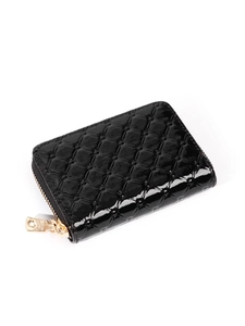 Detail of black patent leather card holder with quilted texture and gold zipper