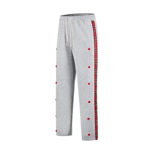 Detail of grey joggers with red plaid side stripes, buttons and white drawstring