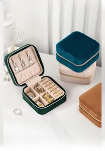 Detail showing velvet jewelry box interior with necklace hooks and ring storage slots