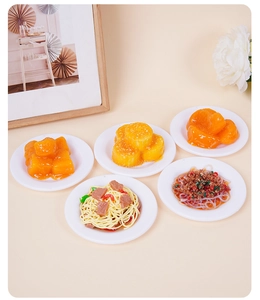 Set of five realistic miniature food models including pasta and desserts on white plates