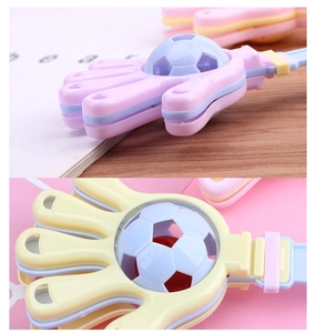 Macro view of multi-layered macaron color hand clapper toy with football design detail