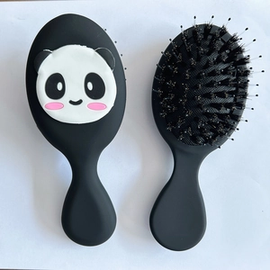 Detail of cute panda hair brush set with natural boar bristles and matte black handles