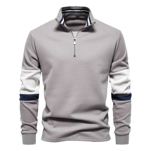 Detail of grey half-zip sweatshirt featuring navy and white striped collar and sleeve accents