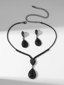 Detail of luxury teardrop black rhinestone necklace and matching earrings bridal set